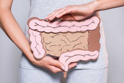 Woman holds gut picture